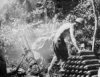 Gun crew firing 4.2-inch mortar in New Guinea during WWII - click to enlarge